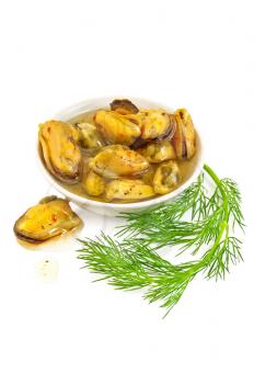 Mussels with spices and butter in a dish, a sprig of dill is isolated on a white background
