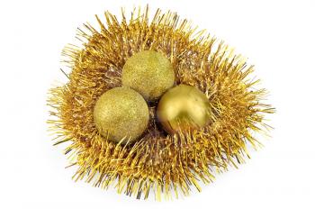 A nest of golden tinsel with three golden balls isolated on a white background