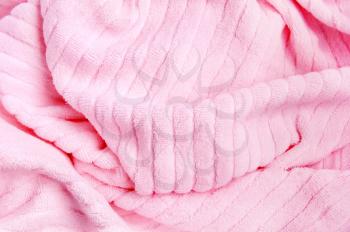 The pink towel lying loose folds
