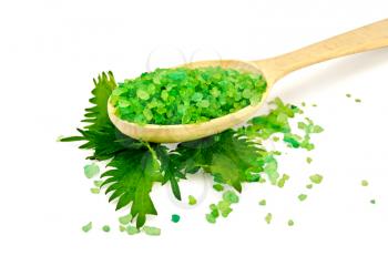 Green bath salt on a wooden spoon with nettle isolated on white background