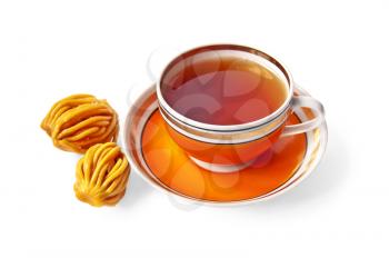 Tea in the orange cup with oriental sweets isolated on white background
