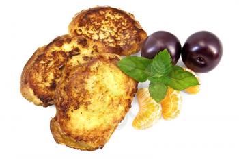 Three golden fried toast, two plums, three segments of mandarin, mint sprig isolated on a white background