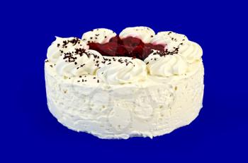 Round sponge cake with white cream and red jam on a blue background