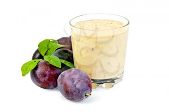Milkshake in a glass beaker with plums and green leaves it is isolated on a white background