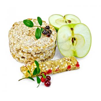 Granola bar, cereals stack crispbreads, sliced ​​green apple, branches with leaves and berries lingonberries isolated on white background