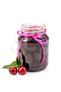 Cherry jam in a glass jar, two cherries on a branch with leaves isolated on white background