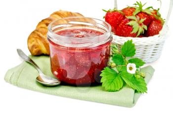 Strawberry jam in a glass jar, layered bun, strawberry, napkin, spoon isolated on white background