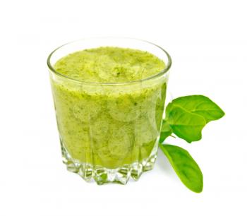 Low glass cup with a cocktail of spinach, spinach leaves isolated on white background