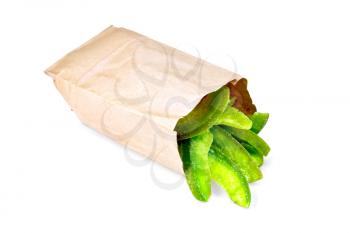 Green slices of candied pomelo in a paper bag isolated on white background