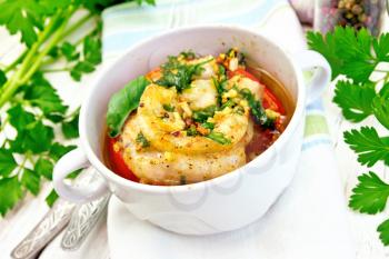 Fish baked in tomato in Zandvoort in white bowl on a napkin, parsley on a wooden boards background