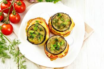 Toasted with egg, tomato, cheese and eggplant slices of bread, sprinkled with dill and parsley in a dish on napkin on the background of wooden countertop top