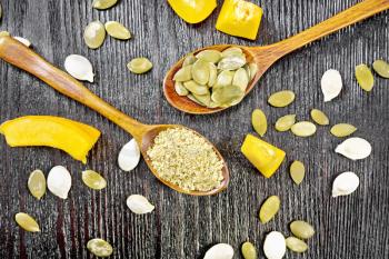Flour and pumpkin seeds in spoons, slices of vegetable on a wooden board background from above