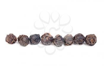 Royalty Free Photo of a Line of Black Peppercorns