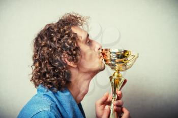 Man being awarded with golden cup