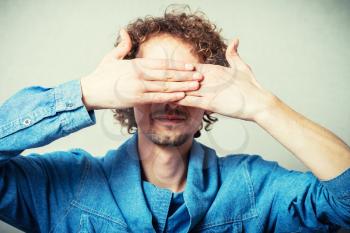 man closes his eyes with his hands