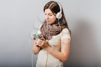girl in headphones with a mobile