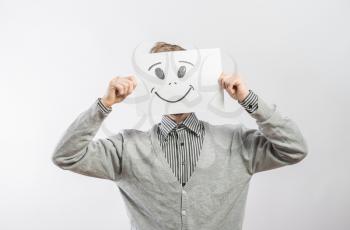 Man with the painted happy smile on the sheet of paper