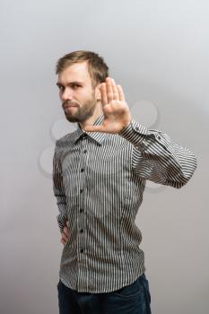 young strictly man making stop with his hand 