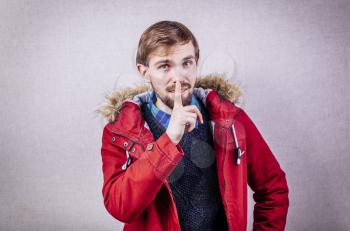 young man making silence gesture, shhh!!