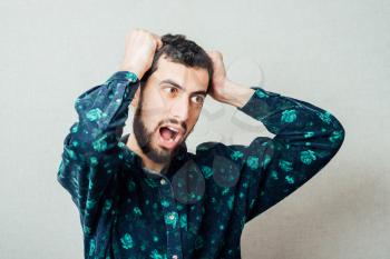 Young handsome man shouting with  beard and freckles