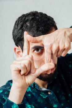 Young hipster man focusing with his fingers