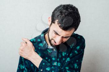 Close-up of a young man suffering from shoulder pain 