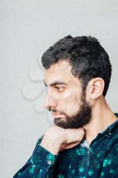 Portrait of young sad man worrying or having pain