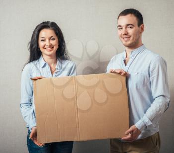 two smiling at a blank board