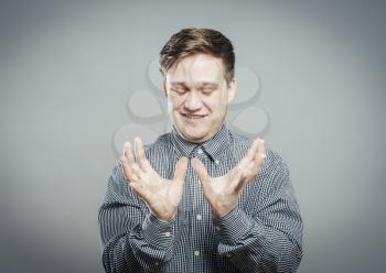 young man looking shocked and surprised in full disbelief hands up in air