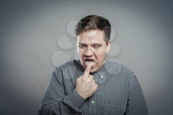 young man with finger in mouth