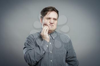 a young man feels toothache