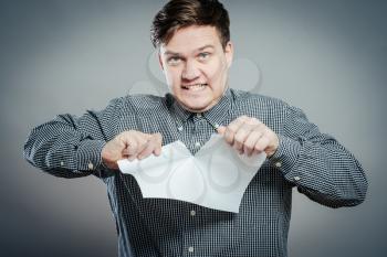 Angry man tear out paper