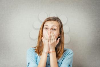 Young scared woman covering the mouth.