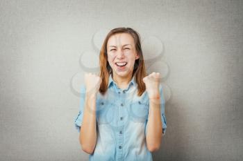 woman victory gesture hands up. isolated on gray background