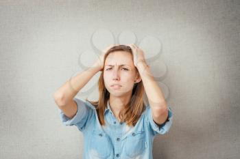 Girl with headache holding her head