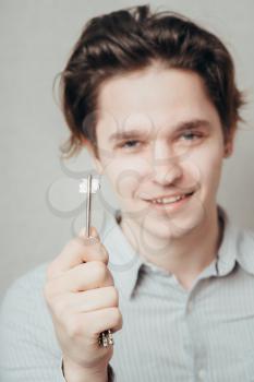 young man holding a key