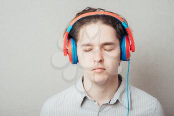 portrait of a young happy man listening to music