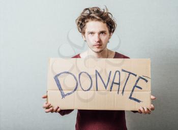 man, holding a picture with the inscription donate