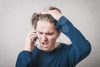 frustrated man talking on the phone