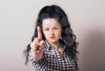 Woman shows an index finger upwards
