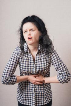 an image of Businesswoman with abdominal pains