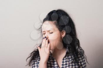 Young woman yawning