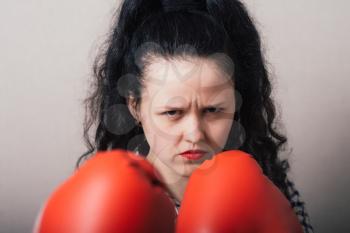 businesswoman with boxing gloves ready for fighting