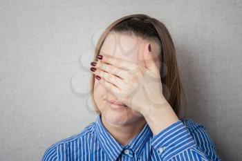 young girl covering her eyes/ isolated