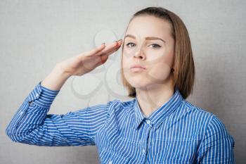 Attractive business woman saluting.