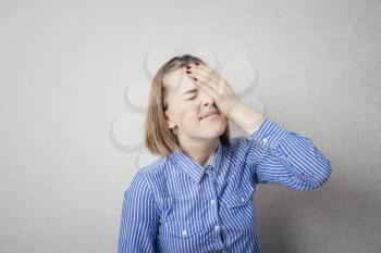 upset young woman with hand on his head