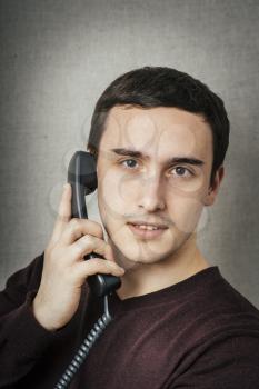 Portrait of a smiling businessman on phone in his office