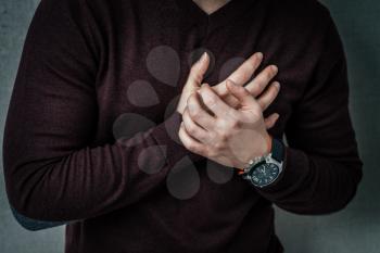 Young man with strong lungs ache holding his chest