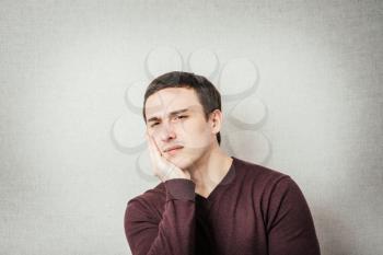 a young man with a toothache