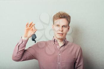 Young man . Holding a car keys